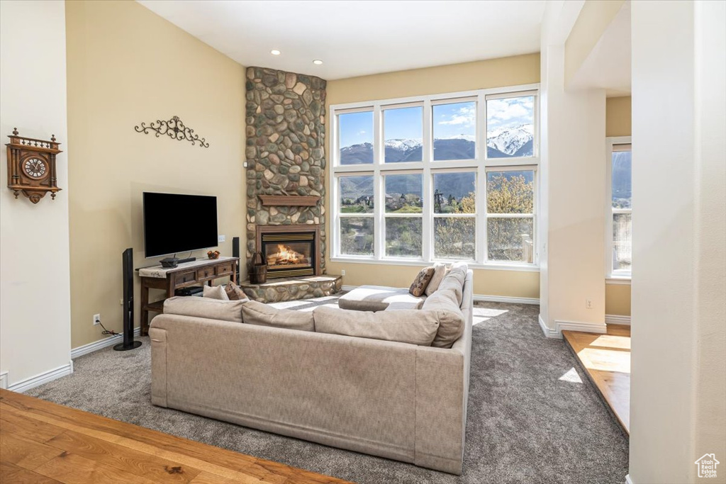 Carpeted living room with plenty of natural light and a fireplace