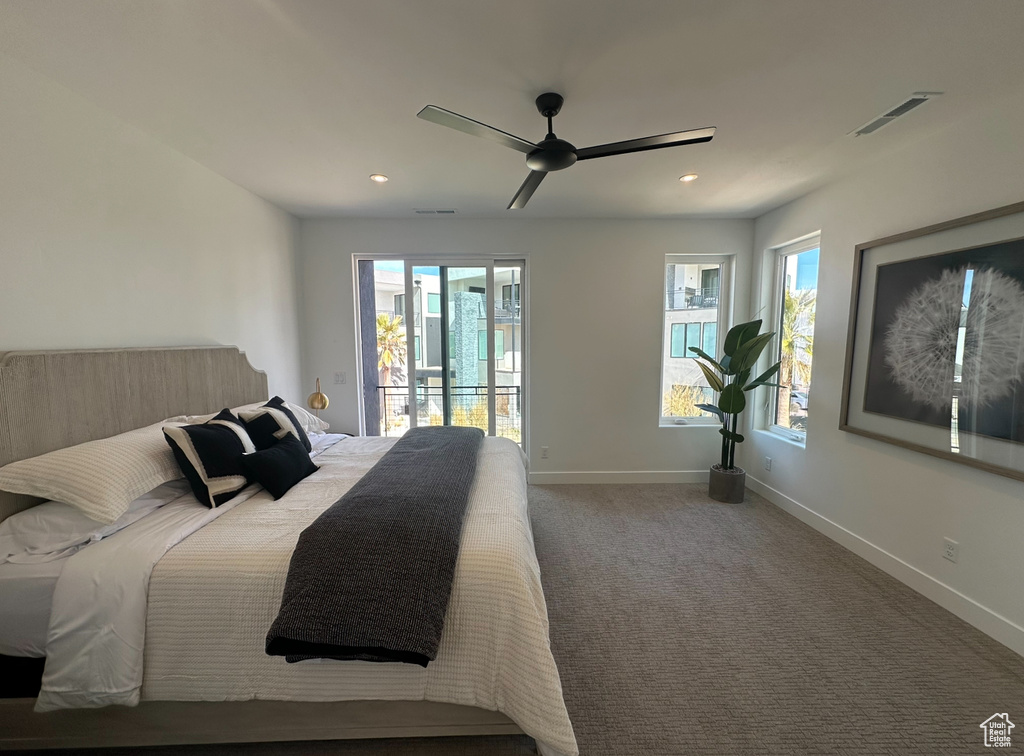 Bedroom featuring access to exterior, ceiling fan, carpet floors, and multiple windows