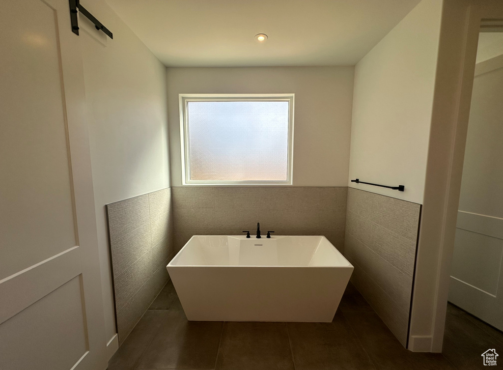 Bathroom featuring tile flooring and tile walls