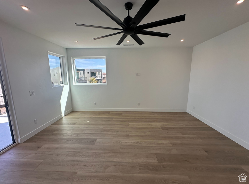Unfurnished room featuring wood-type flooring and ceiling fan