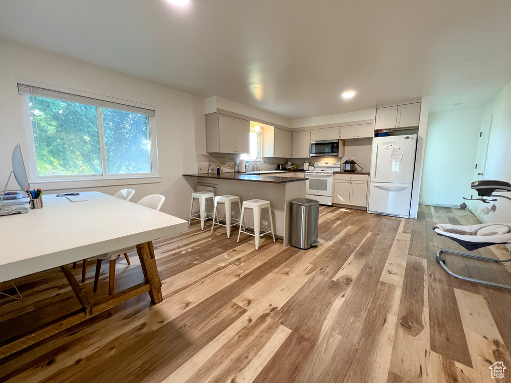 Dining area featuring sink and light hardwood / wood-style floors