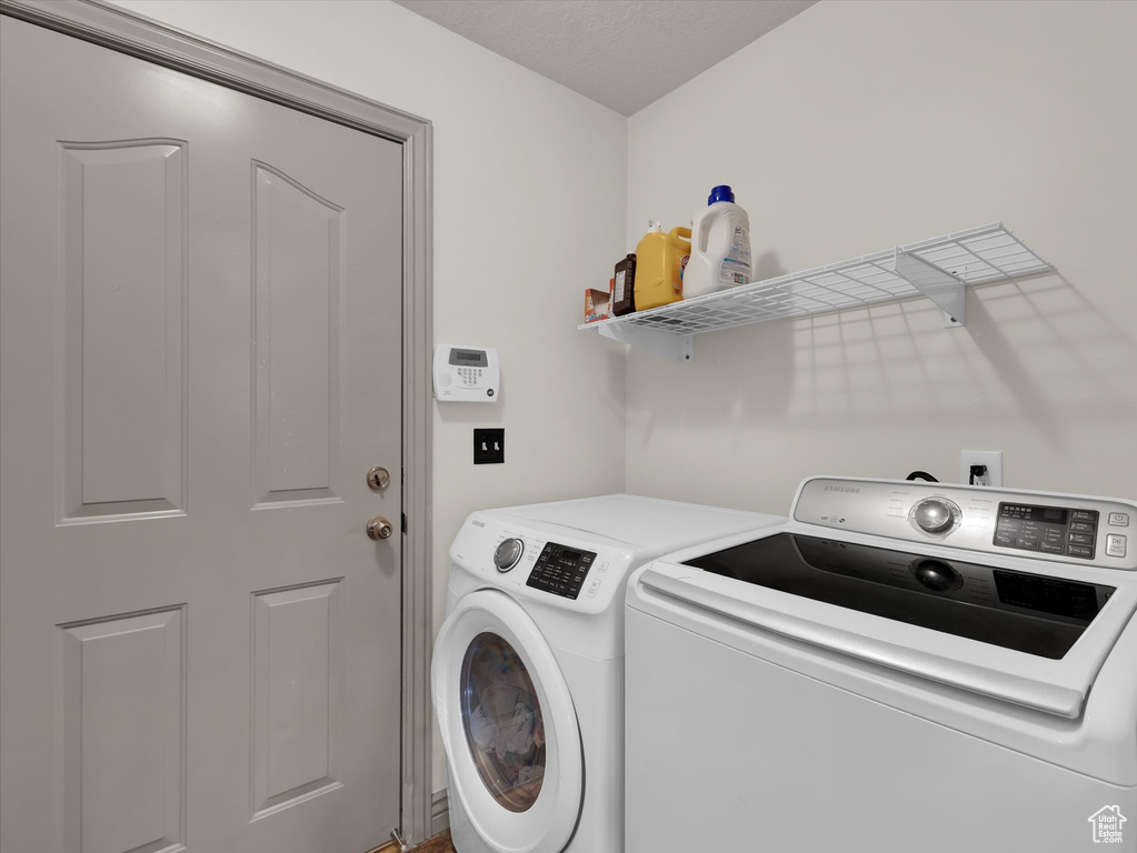 Washroom featuring washing machine and clothes dryer
