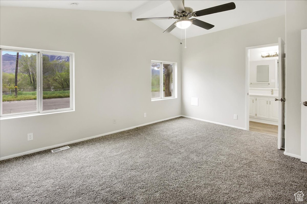 Unfurnished bedroom featuring beamed ceiling, high vaulted ceiling, carpet flooring, connected bathroom, and ceiling fan
