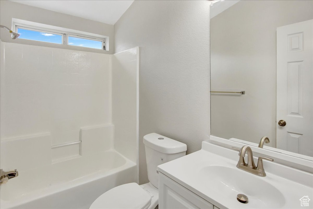 Full bathroom featuring toilet, vanity, and  shower combination