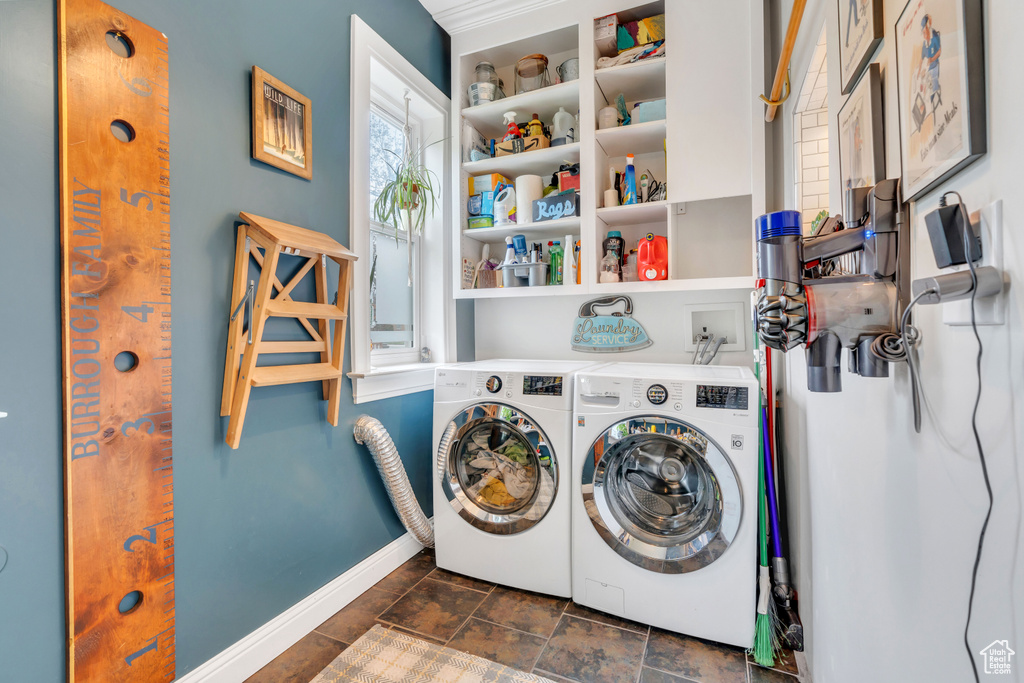 Laundry room with dark tile flooring, washer hookup, and washer and dryer