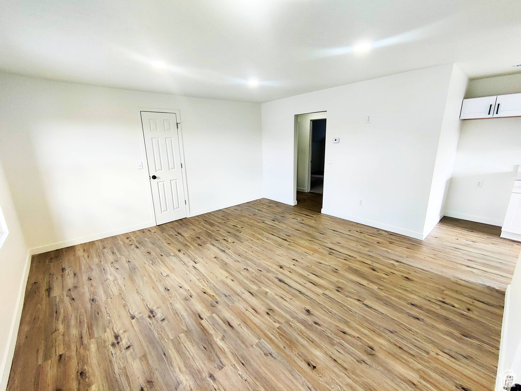 Unfurnished room with hardwood / wood-style flooring