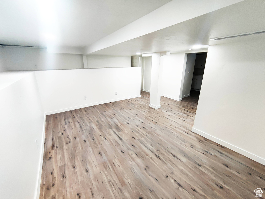 Basement featuring wood-type flooring