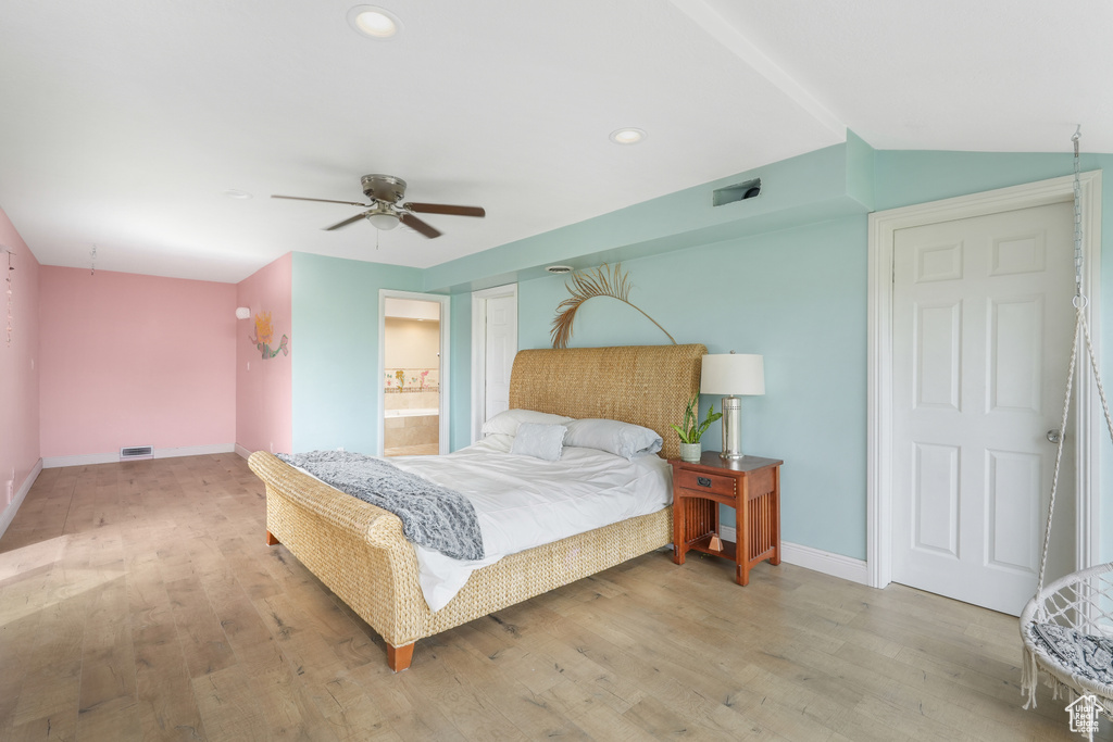 Bedroom featuring ceiling fan, hardwood / wood-style flooring, and ensuite bathroom