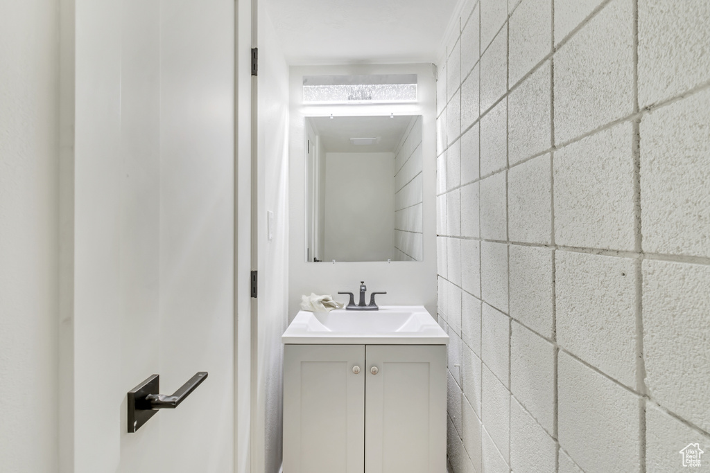Bathroom with tile walls and vanity