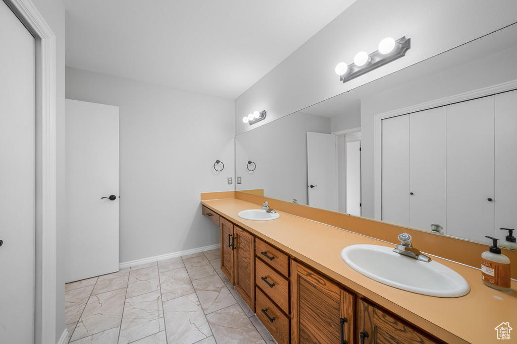 Bathroom with tile floors and double sink vanity