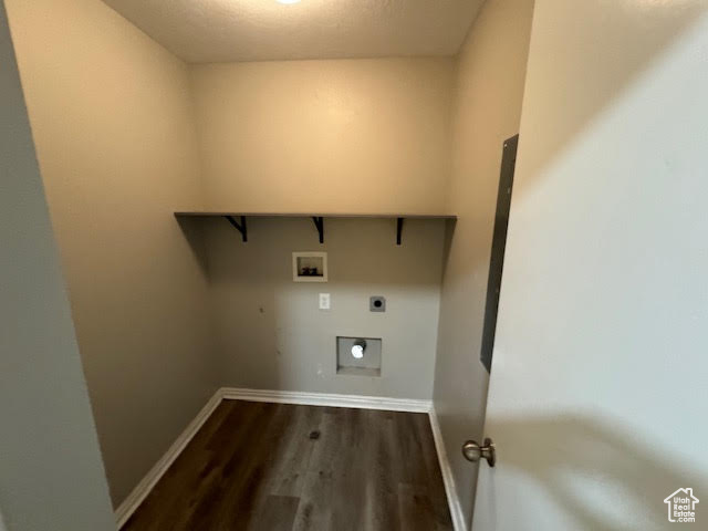 Laundry area with hookup for an electric dryer, hardwood / wood-style flooring, and washer hookup