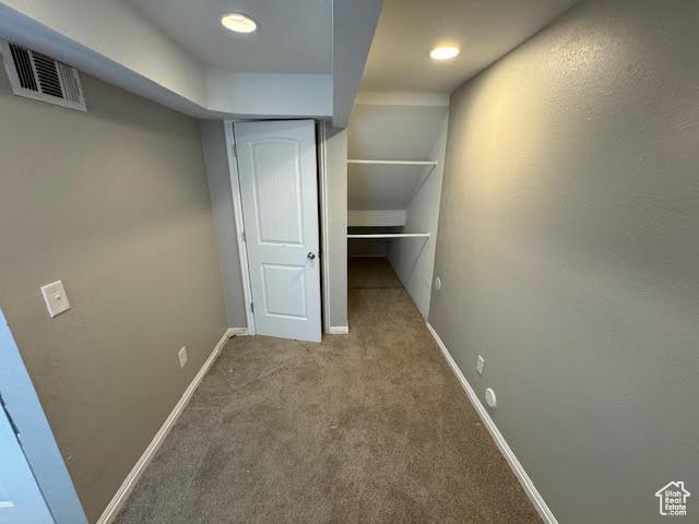 Corridor featuring carpet floors