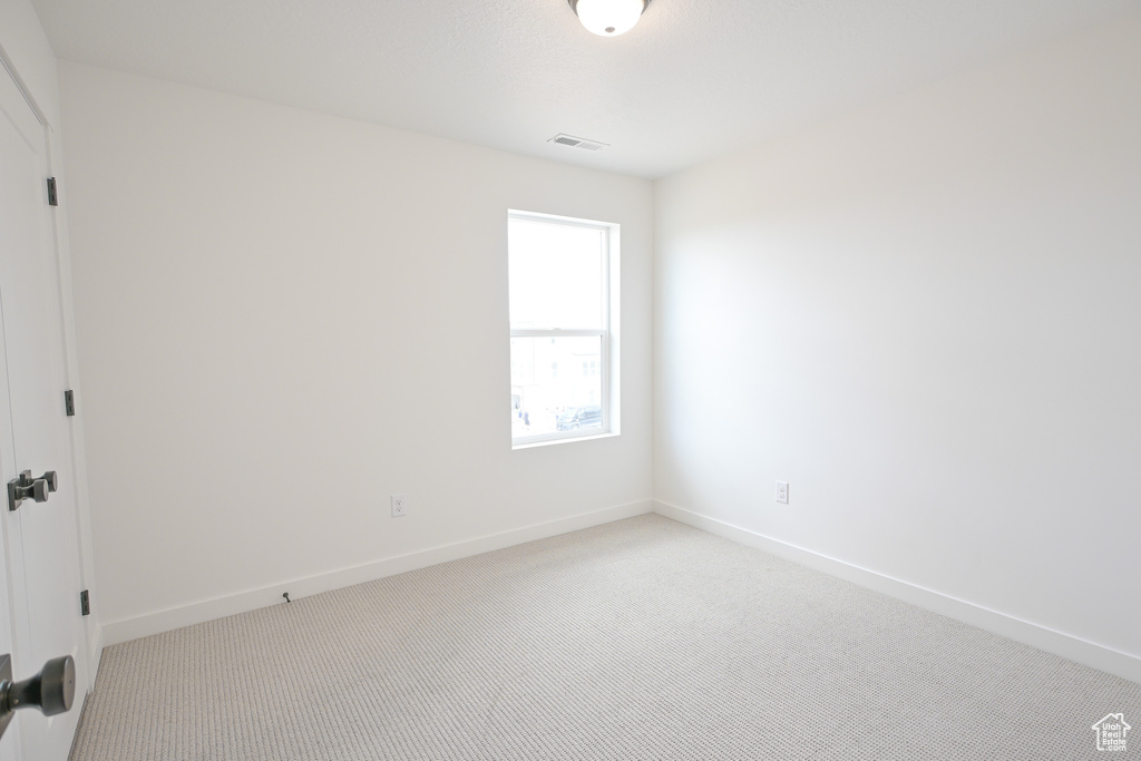 Unfurnished room with carpet