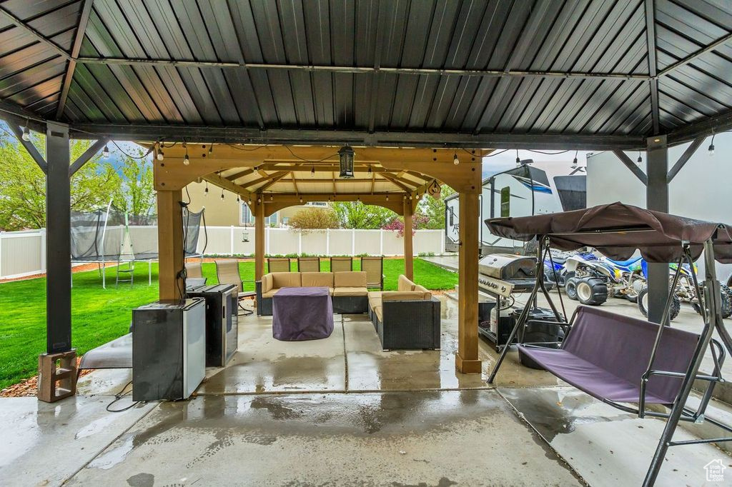 View of patio with outdoor lounge area and a gazebo
