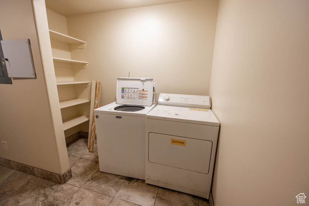 Laundry area with washing machine and dryer and light tile floors