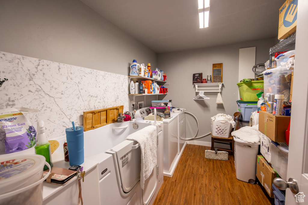 Laundry room featuring hardwood / wood-style floors and washer and clothes dryer