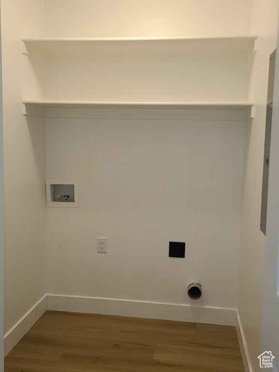 Laundry room with hardwood / wood-style floors, hookup for an electric dryer, and washer hookup