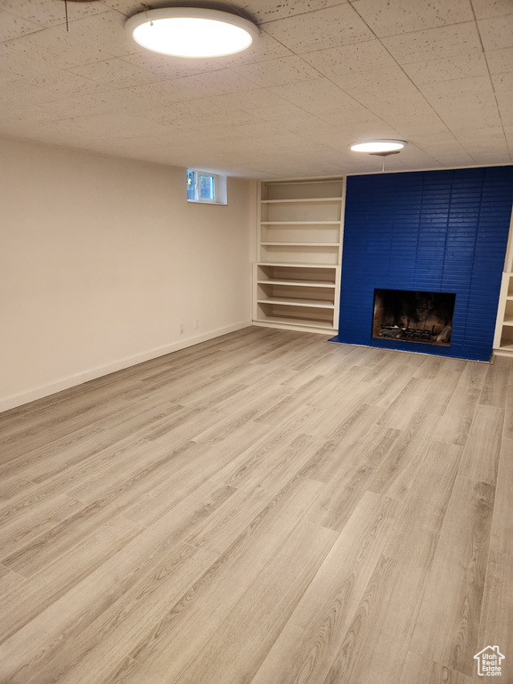 Basement featuring light wood-type flooring