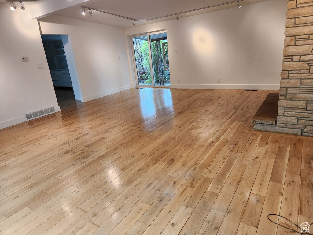 Spare room featuring light hardwood / wood-style floors and track lighting