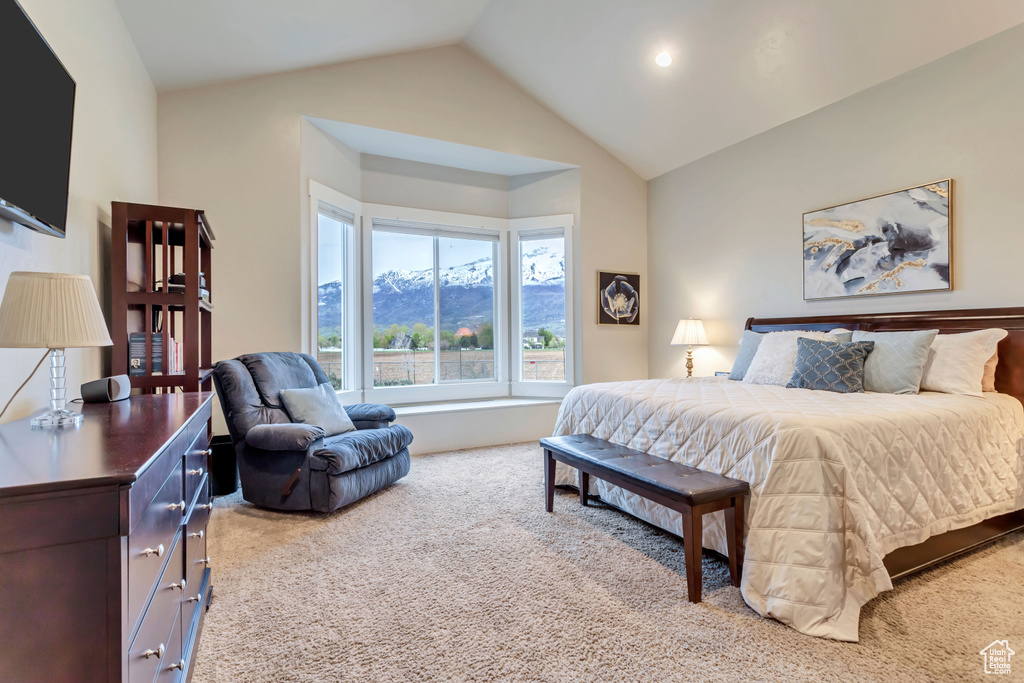 Bedroom with a mountain view, carpet floors, and lofted ceiling