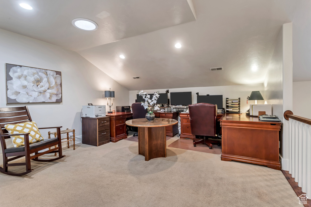 Carpeted office with vaulted ceiling