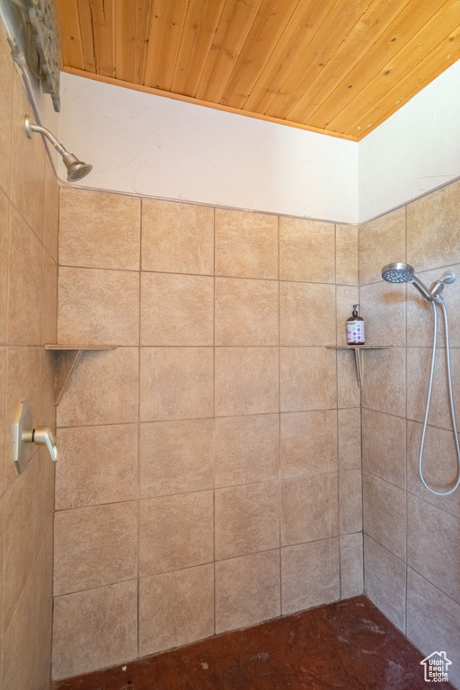 Bathroom with wood ceiling and tiled shower