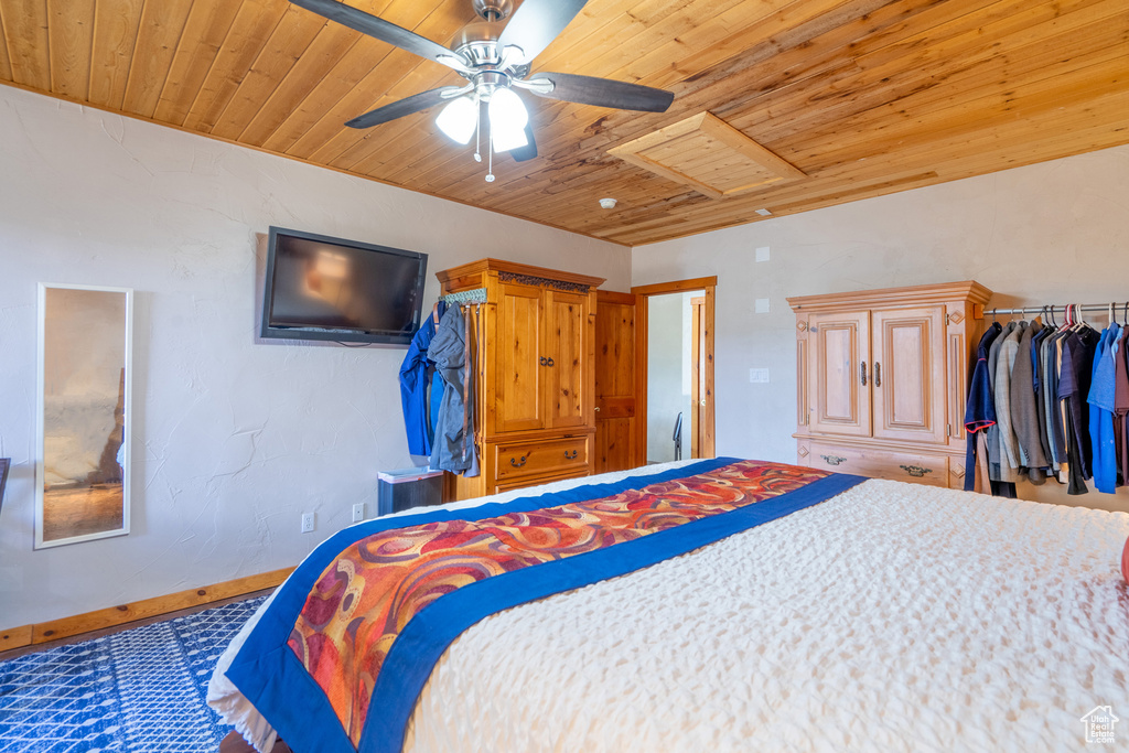 Bedroom with ceiling fan and wood ceiling