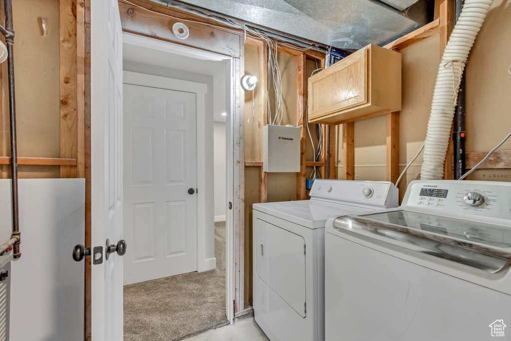Washroom with light colored carpet and washing machine and clothes dryer