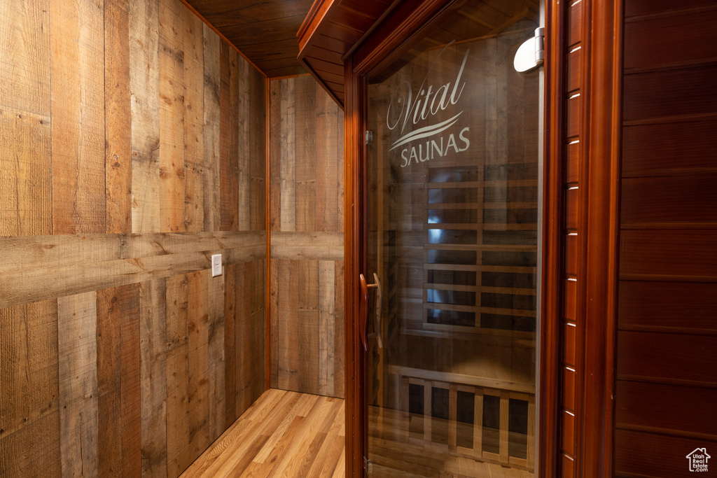 View of sauna / steam room with wood walls