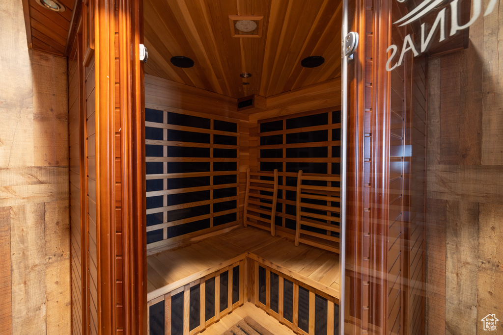 View of sauna / steam room featuring wooden ceiling and wooden walls