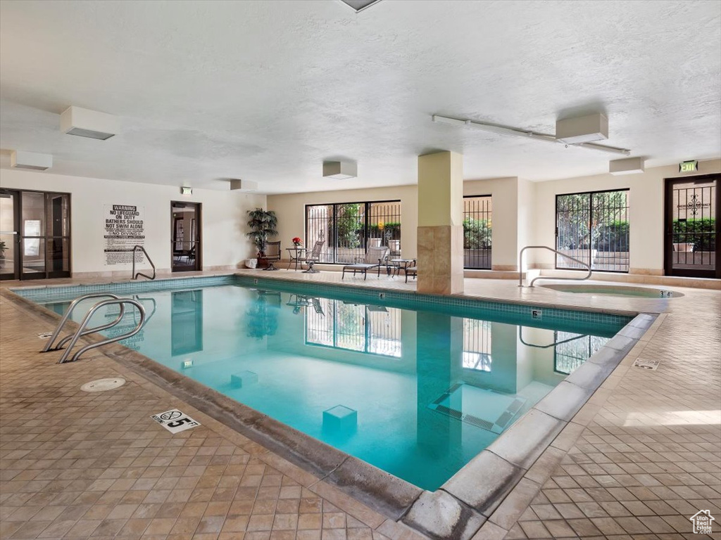 View of pool with an indoor in ground hot tub