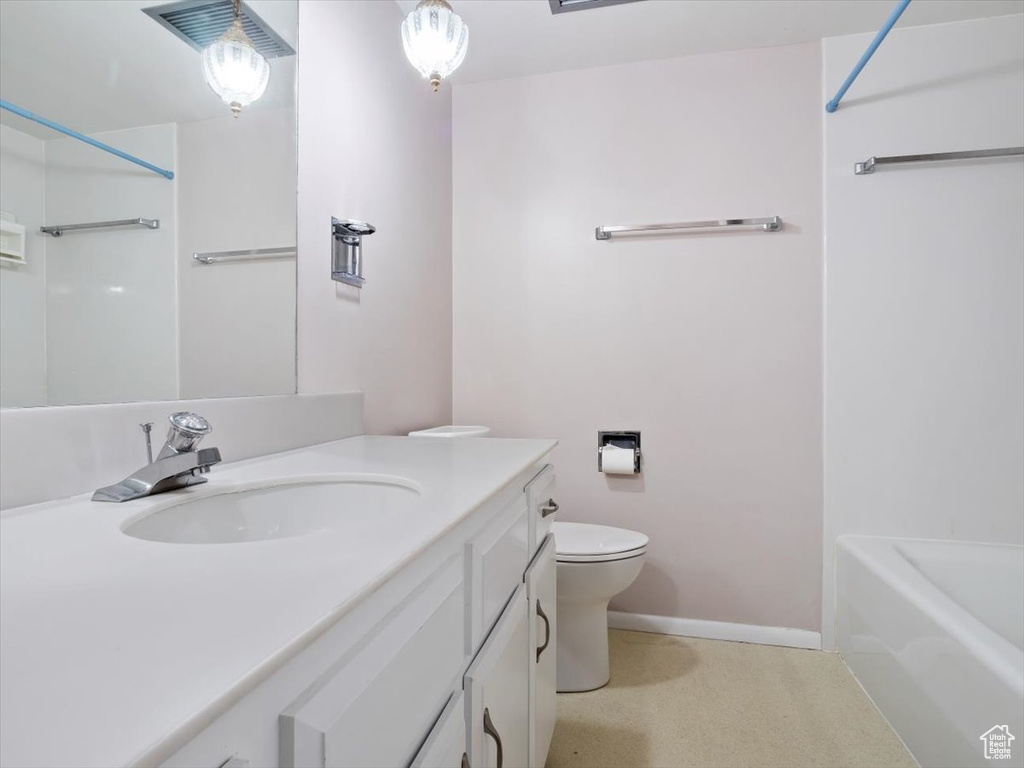 Full bathroom with washtub / shower combination, oversized vanity, and toilet