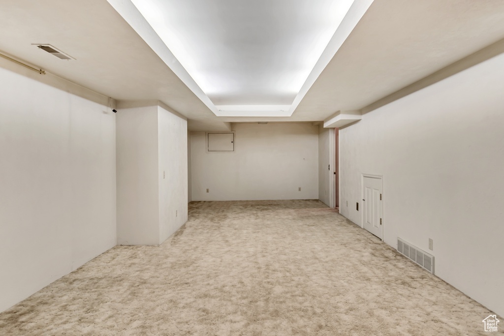 Basement featuring light carpet