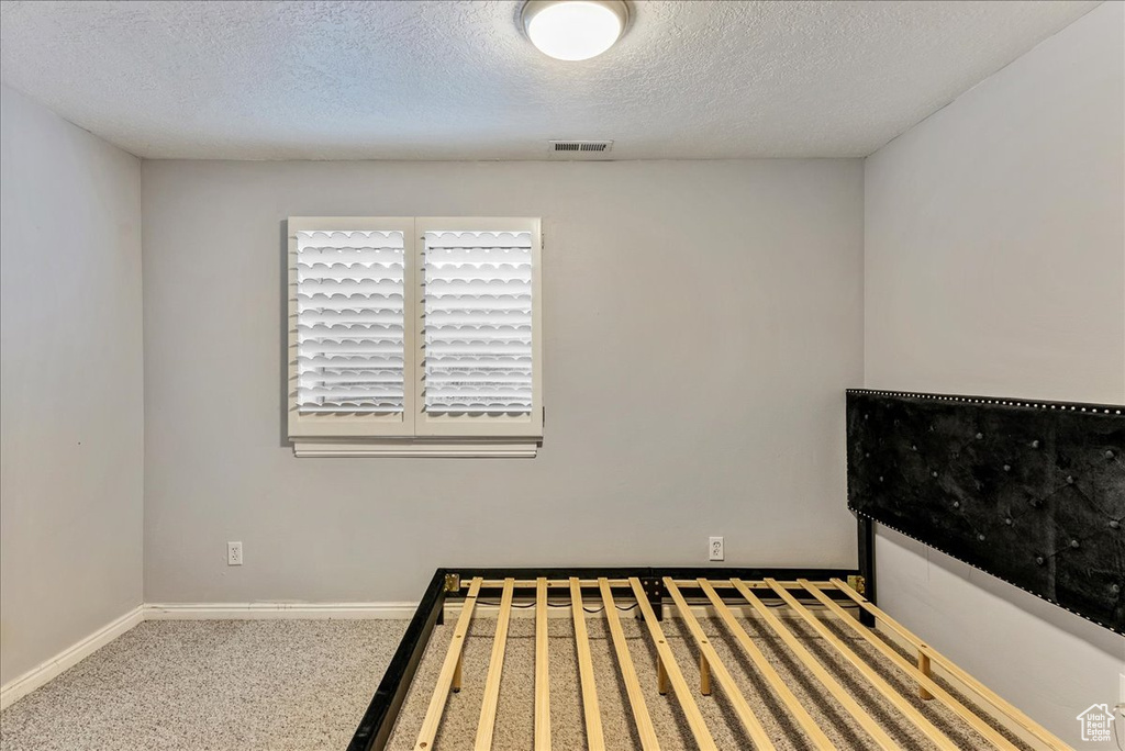 Unfurnished bedroom featuring a textured ceiling