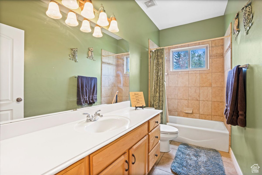 Full bathroom featuring tile floors, shower / tub combo, vanity, and toilet