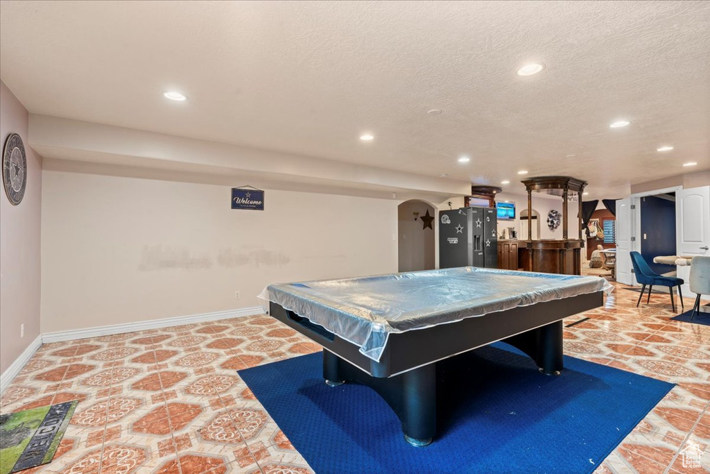 Game room featuring a textured ceiling and billiards