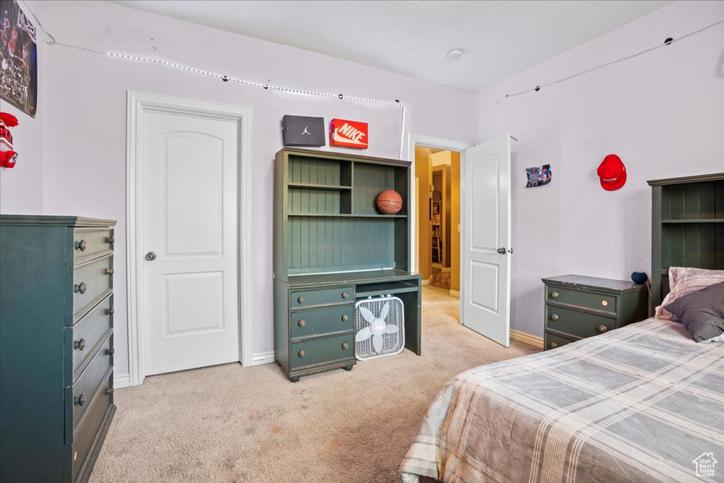 Bedroom featuring light carpet