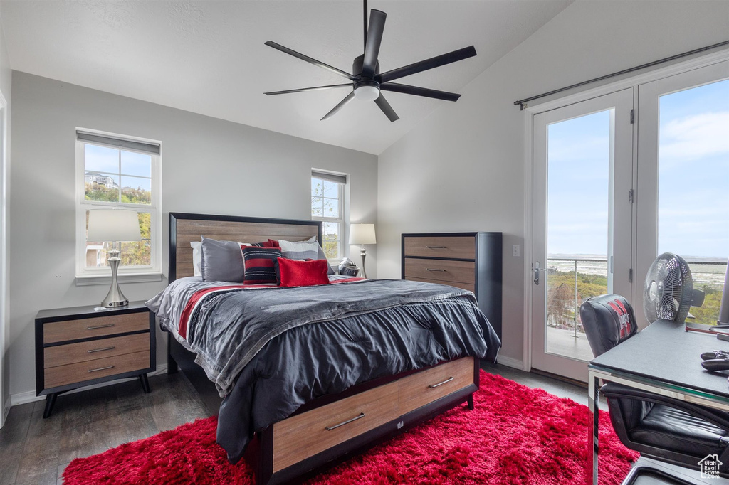 Bedroom featuring ceiling fan, dark wood-type flooring, access to exterior, and multiple windows