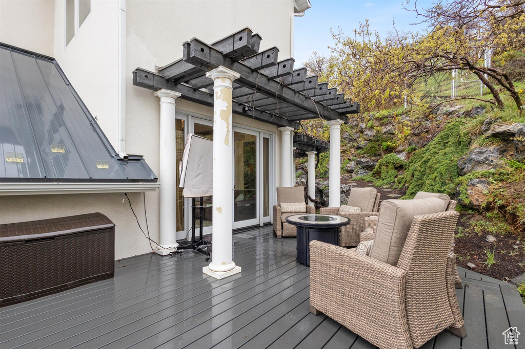 Wooden deck with outdoor lounge area and a pergola