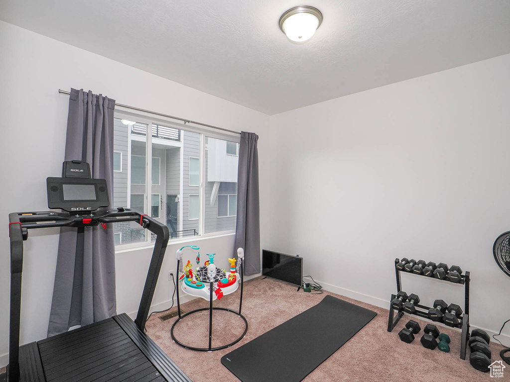 Exercise room with light colored carpet