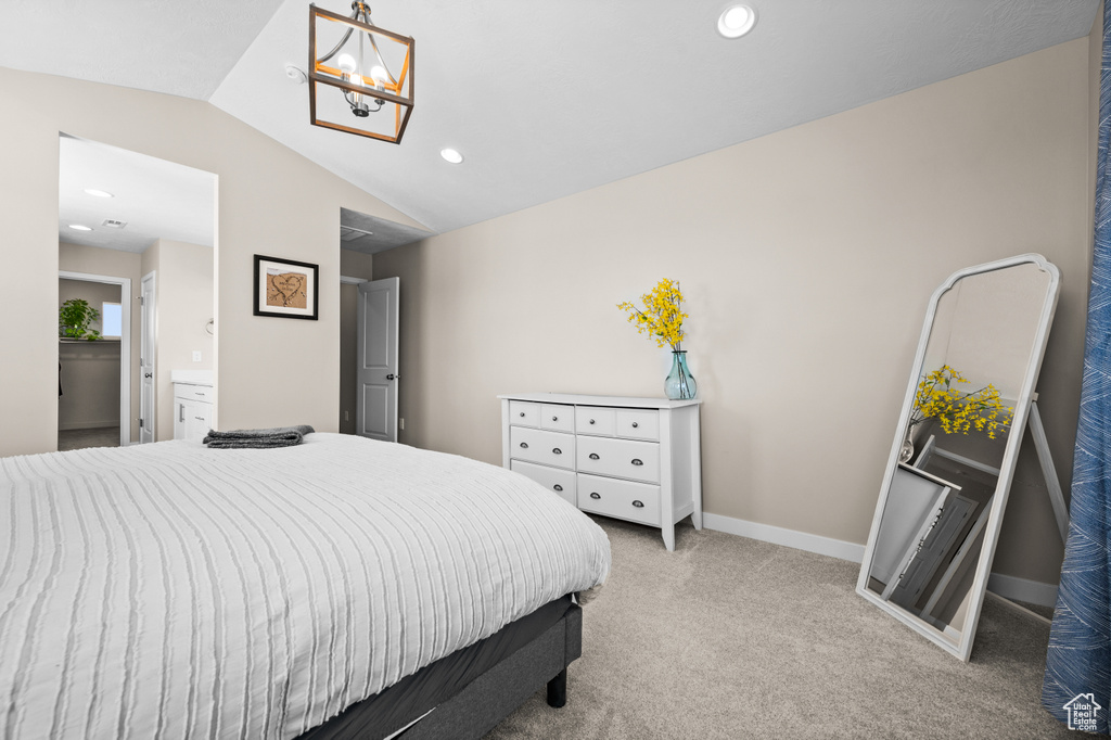 Carpeted bedroom with vaulted ceiling and ensuite bath