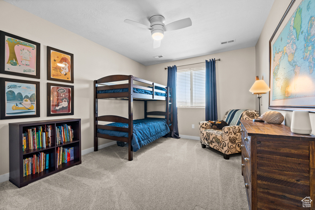 Bedroom with ceiling fan and carpet floors