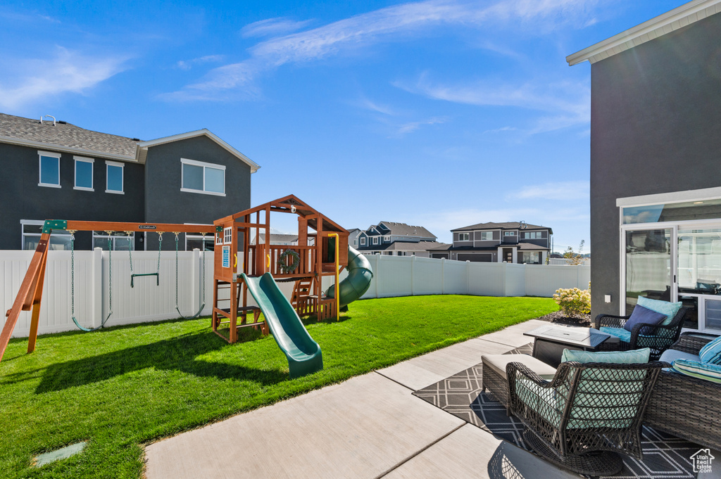 Exterior space with a playground, outdoor lounge area, and a patio area