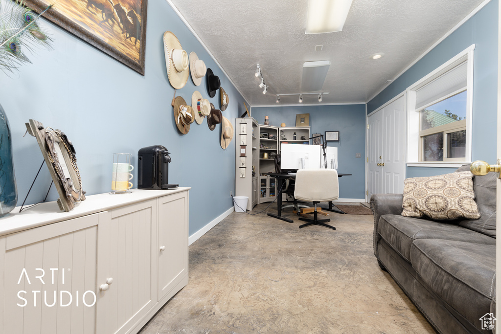 Office space with a textured ceiling and track lighting