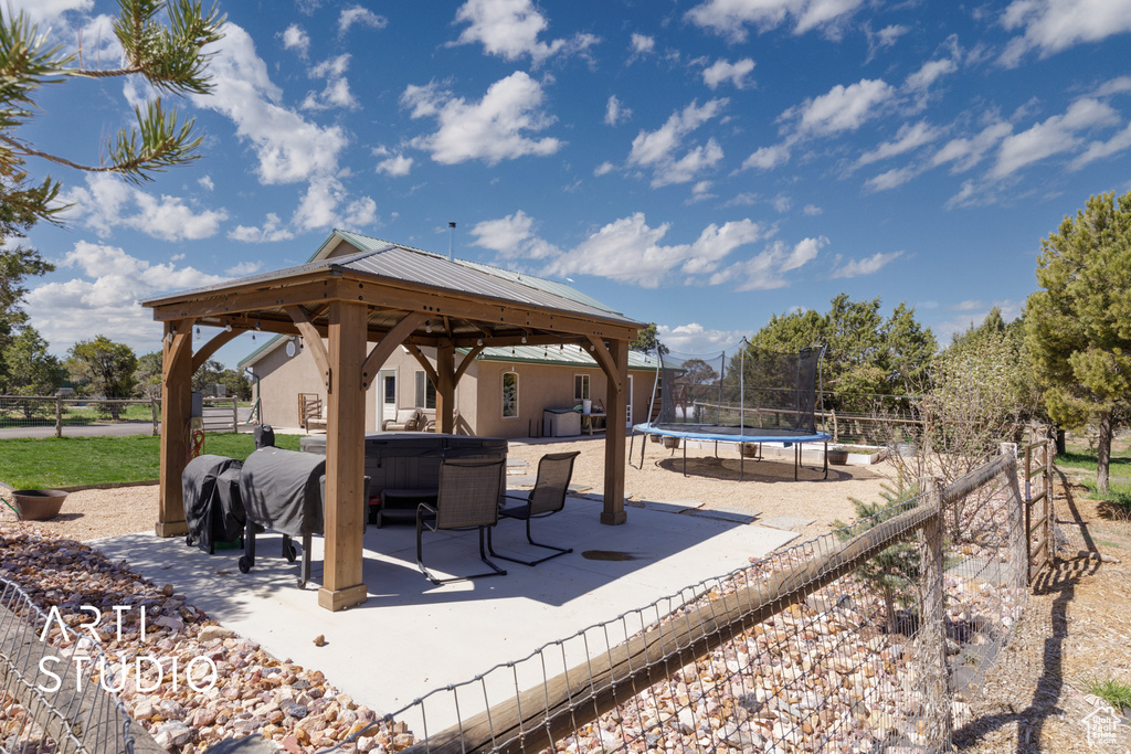 View of patio / terrace featuring a trampoline and a gazebo