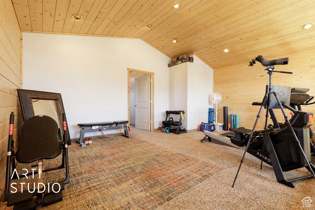 Workout area with carpet flooring, vaulted ceiling, wooden ceiling, and wood walls