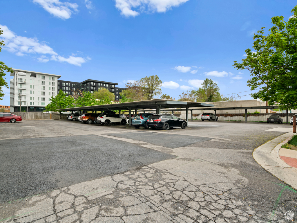 View of parking / parking lot featuring a carport