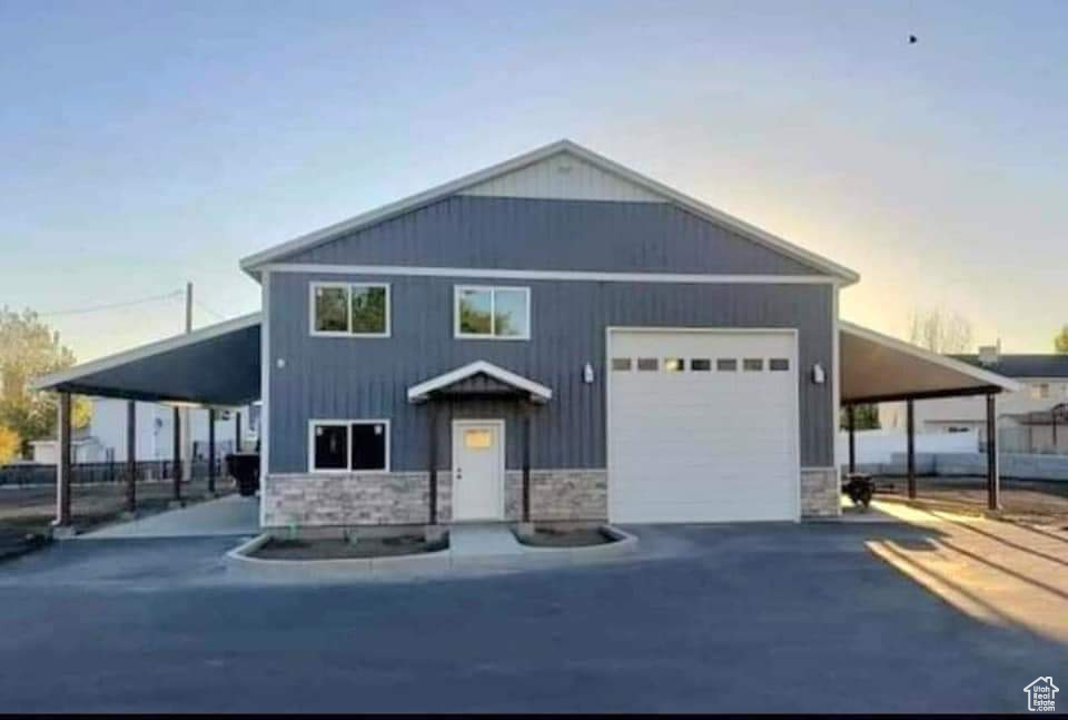 View of front of house featuring a carport and a garage