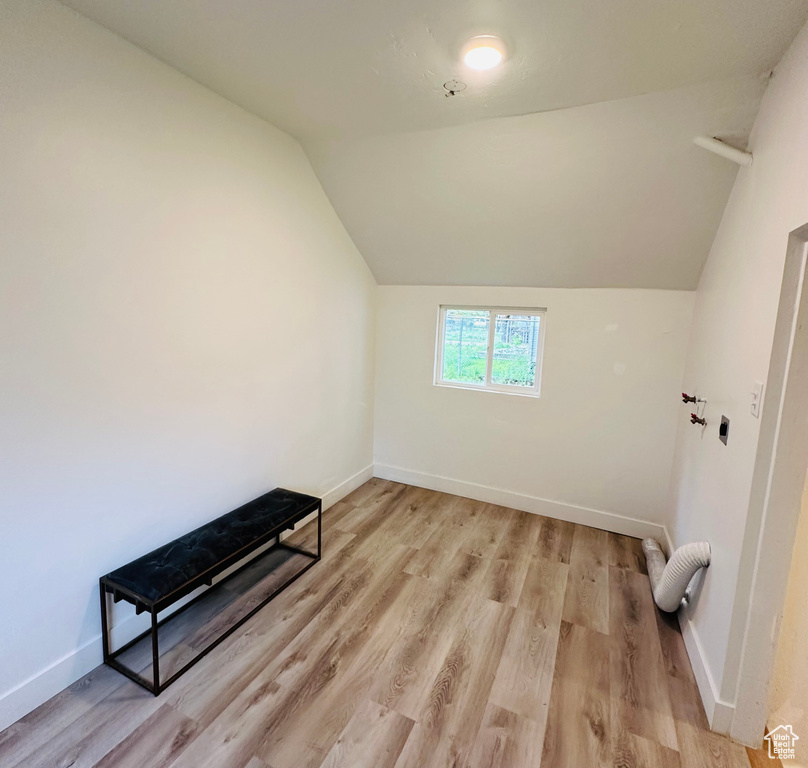 Additional living space featuring vaulted ceiling and hardwood / wood-style flooring
