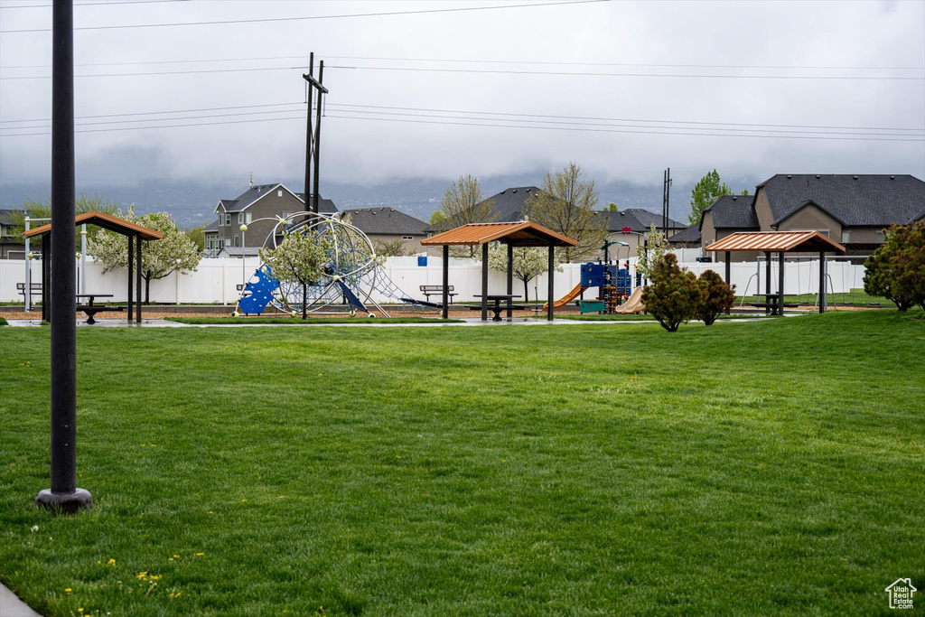 Exterior space featuring a lawn, a playground, and a gazebo